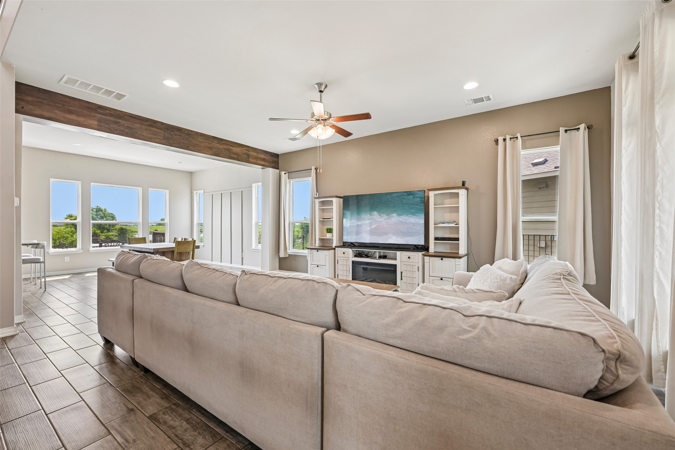 1297 Harwell Loop Kyle, TX 78640 - Photo 10 of 39 An open concept living area boasts elegant flooring and an abundance of natural light.