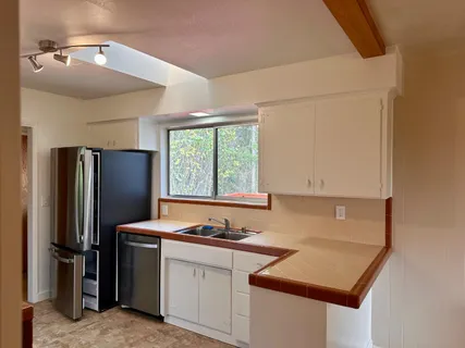 a view of a room with an empty space and a window