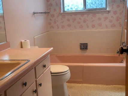 a view of a patio with table and chairs under an umbrella with potted plants
