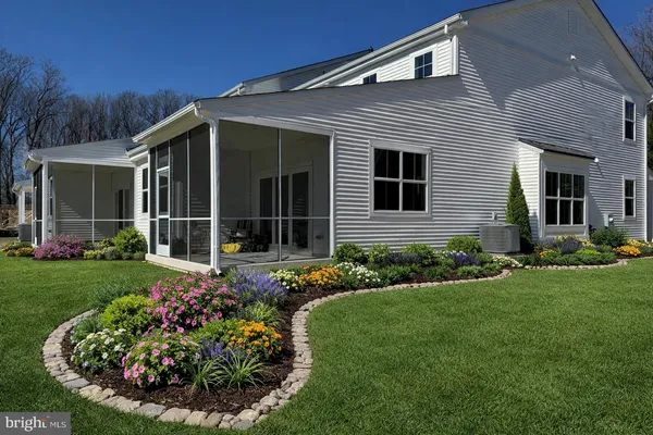 a view of a house with garden and yard