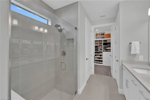 a bathroom with a shower and a sink