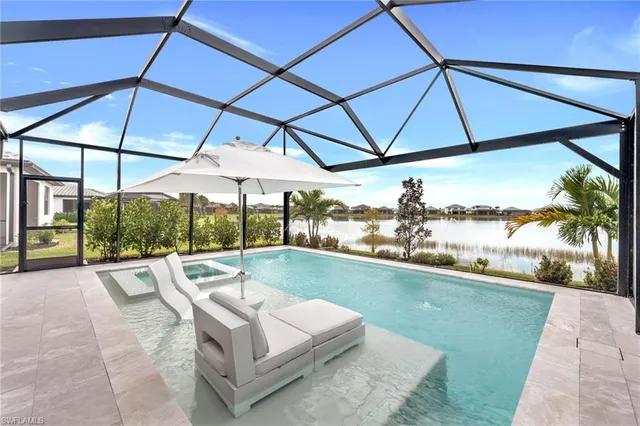 a view of a patio with a table and chairs under an umbrella