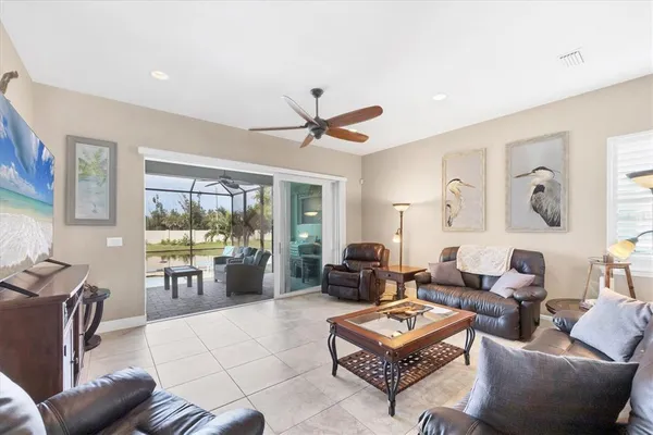 a living room with furniture a table and a large window