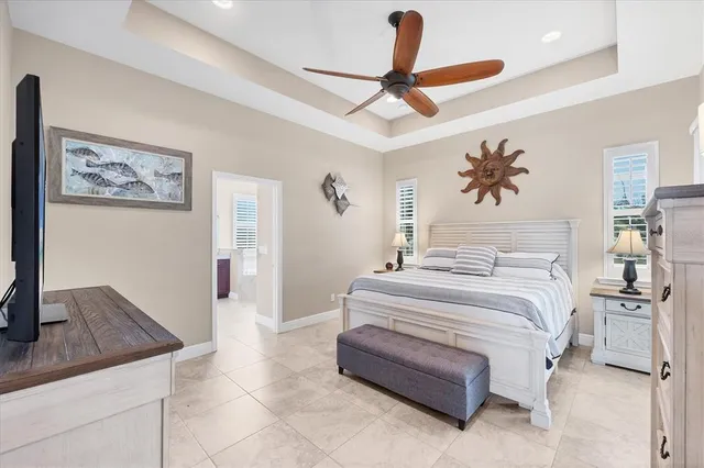 a spacious bedroom with a bed and a ceiling fan