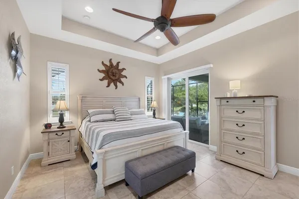 a bedroom with a bed and a chandelier