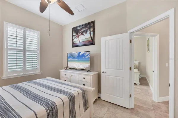 a bedroom with a bed and a painting on the wall