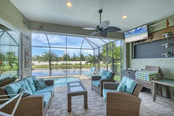a living room with furniture and a floor to ceiling window