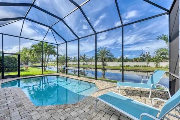 a view of swimming pool with outdoor seating
