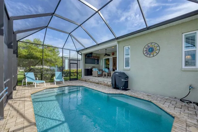a swimming pool with outdoor seating