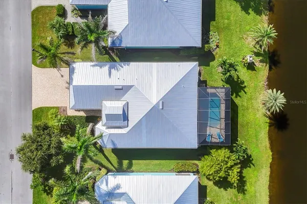 an aerial view of a house with a yard