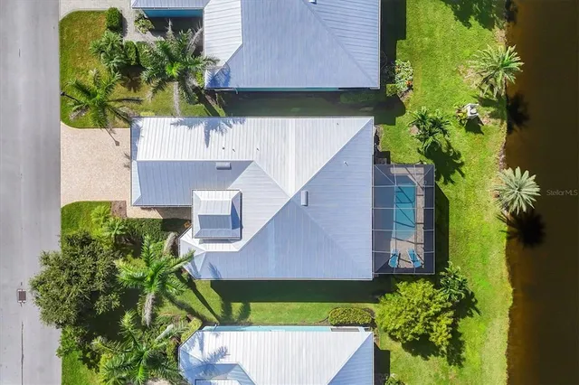 an aerial view of a house with a yard