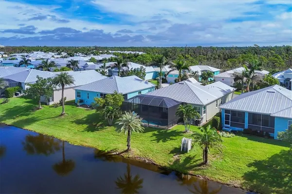 a view of a house with a yard and sitting area