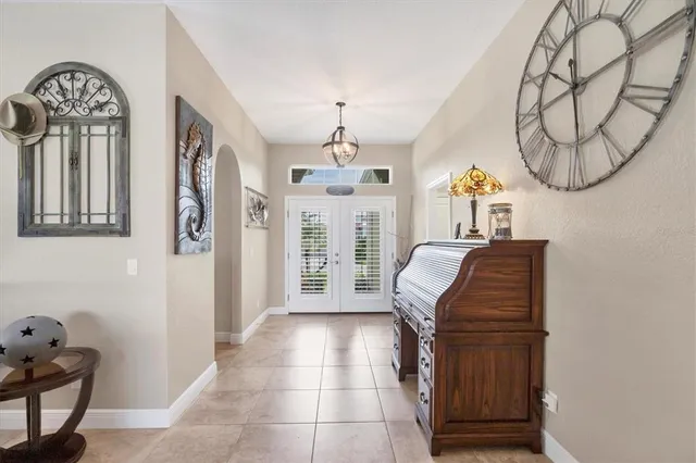 a living room with furniture a chandelier and a window
