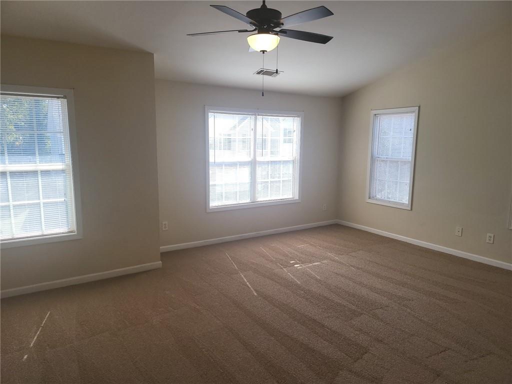 91 Meeting Pl Road Lawrenceville, GA 30044 - Photo 11 of 18 an empty room with a window and a kitchen