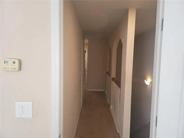 a view of a hallway with a room