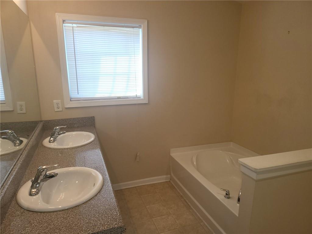91 Meeting Pl Road Lawrenceville, GA 30044 - Photo 13 of 18 a bathroom with a sink and a mirror
