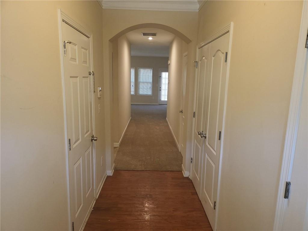 91 Meeting Pl Road Lawrenceville, GA 30044 - Photo 5 of 18 a view of a hallway with wooden floor and closet area