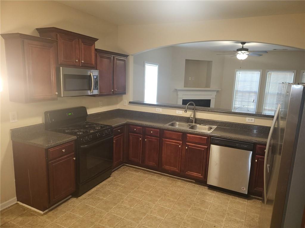91 Meeting Pl Road Lawrenceville, GA 30044 - Photo 6 of 18 a kitchen with stainless steel appliances granite countertop a sink stove and microwave