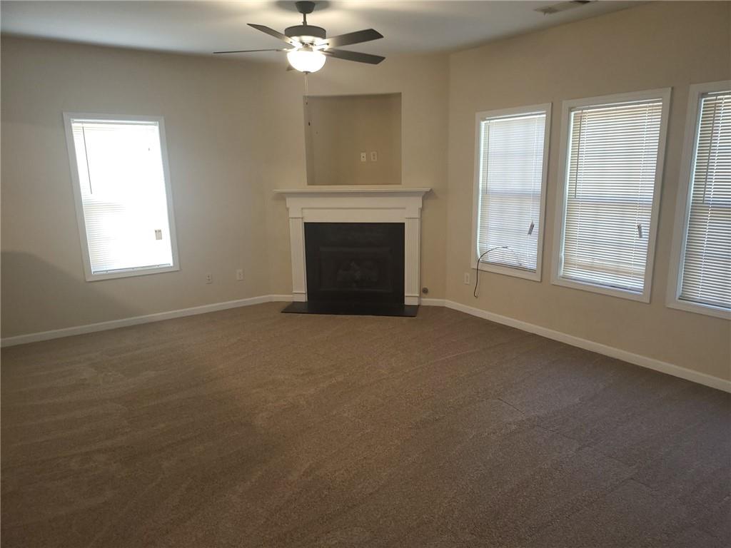 91 Meeting Pl Road Lawrenceville, GA 30044 - Photo 8 of 18 an empty room with windows and fireplace