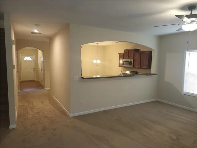 a view of a livingroom with furniture and a window