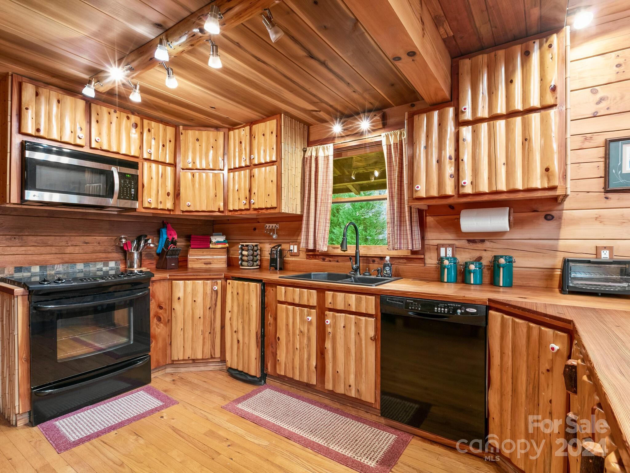 354 Nelons Road Mill Spring, NC 28756 - Photo 16 of 32 a kitchen with stainless steel appliances granite countertop a stove sink and cabinets