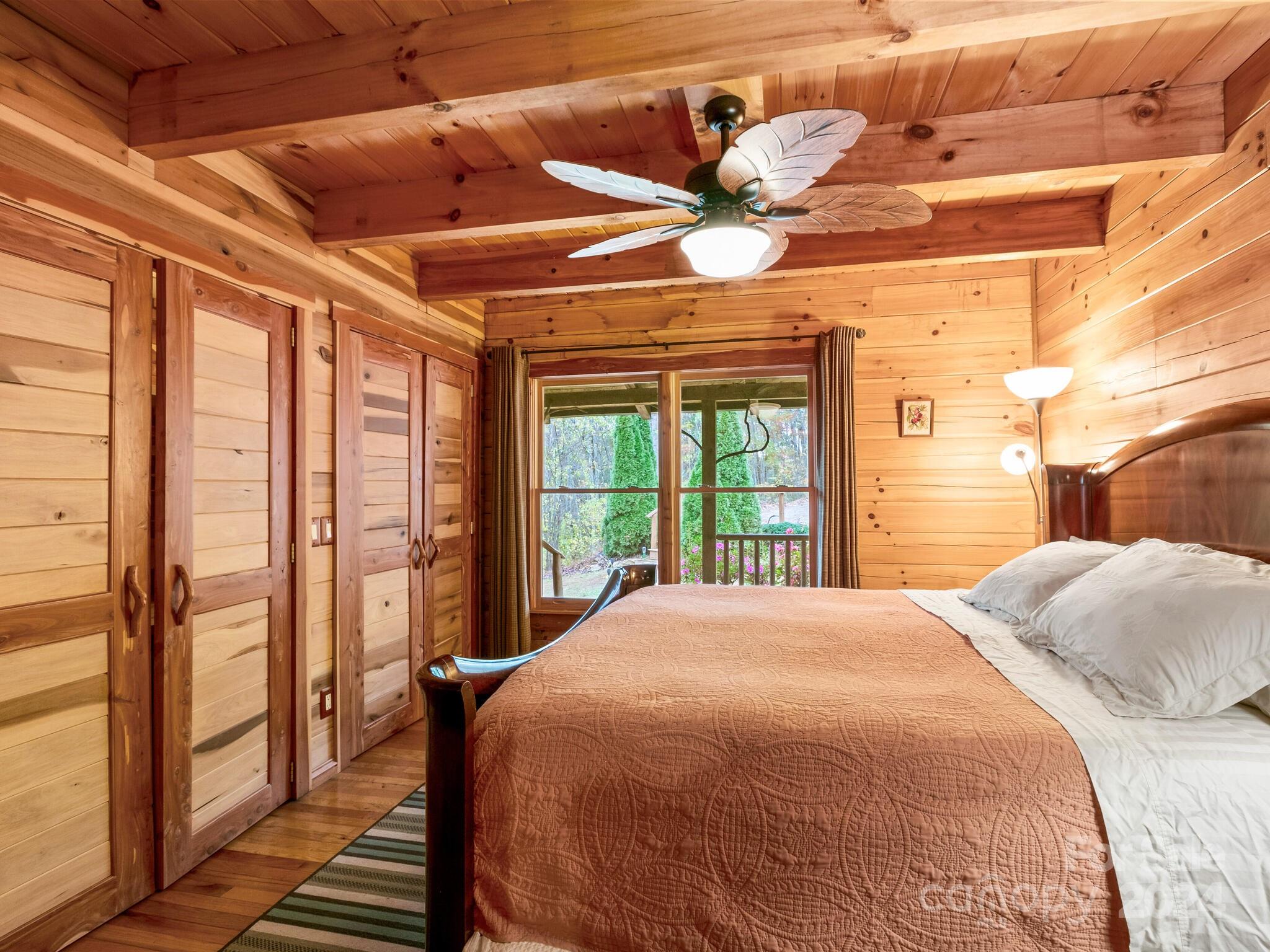 354 Nelons Road Mill Spring, NC 28756 - Photo 20 of 32 a bedroom with a bed and a large window