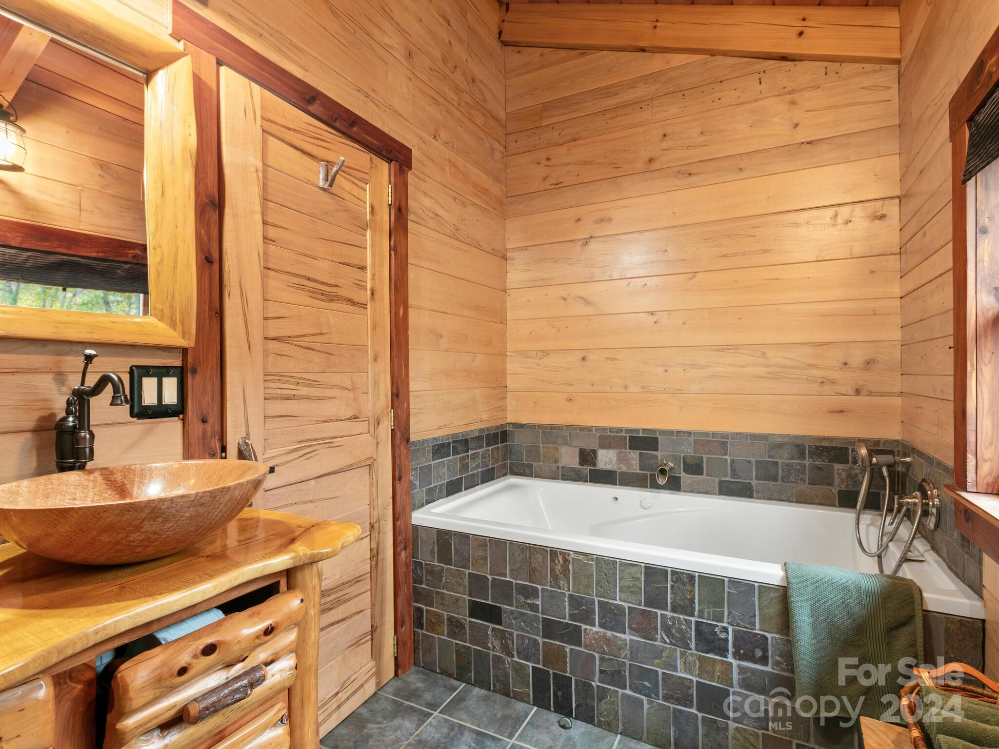 354 Nelons Road Mill Spring, NC 28756 - Photo 25 of 32 a bathroom with a sink and a mirror