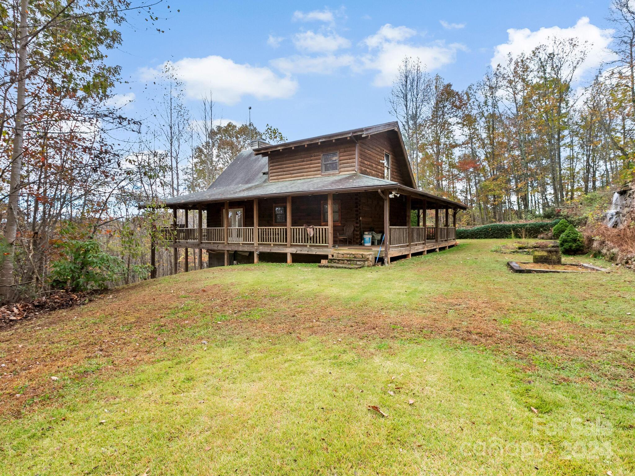 354 Nelons Road Mill Spring, NC 28756 - Photo 28 of 32 a view of a house with a big yard and large trees