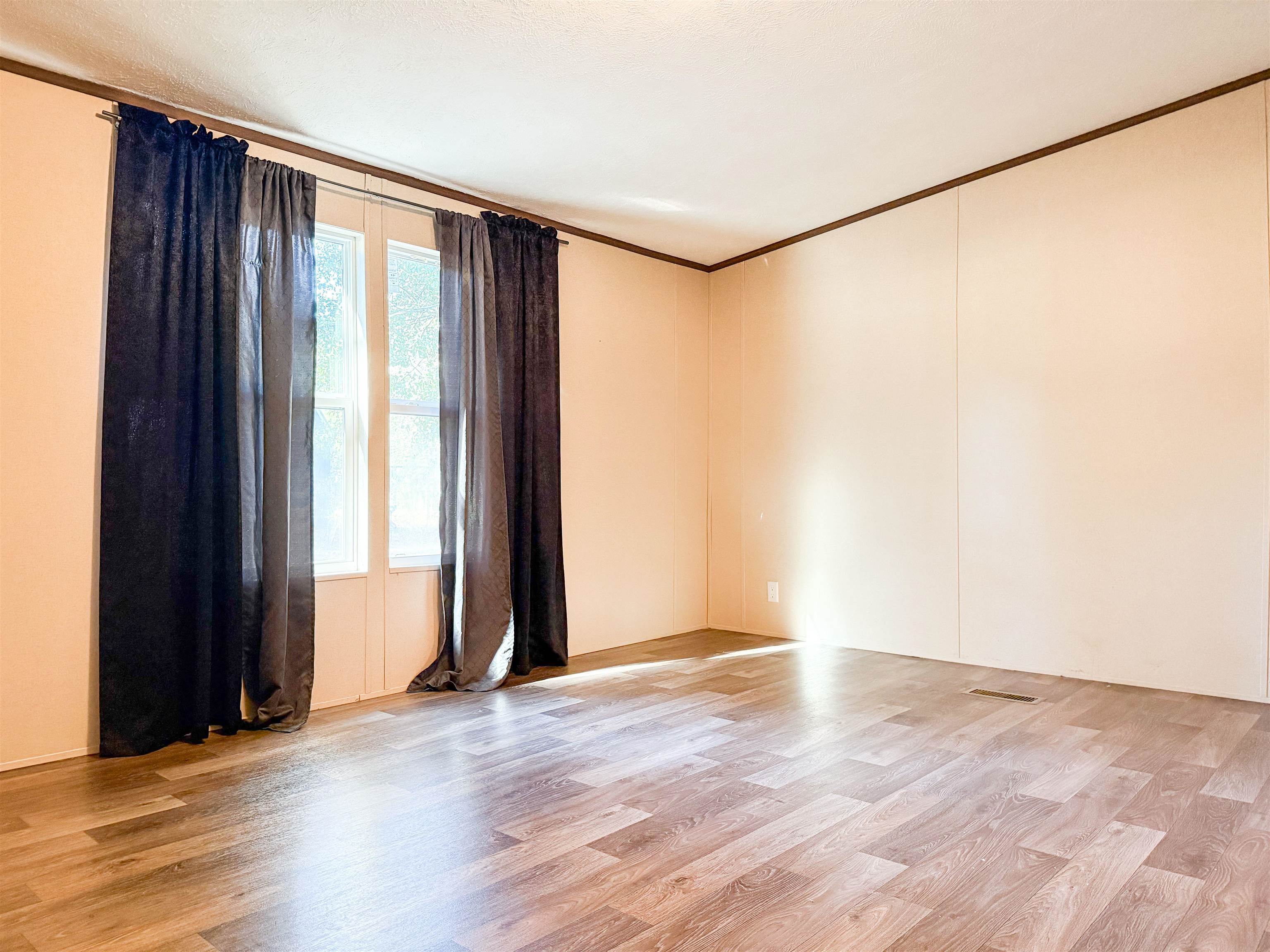 279 Travis Road Brewton, AL 36426 - Photo 2 of 17 Spare room featuring ornamental molding and light wood-style floors