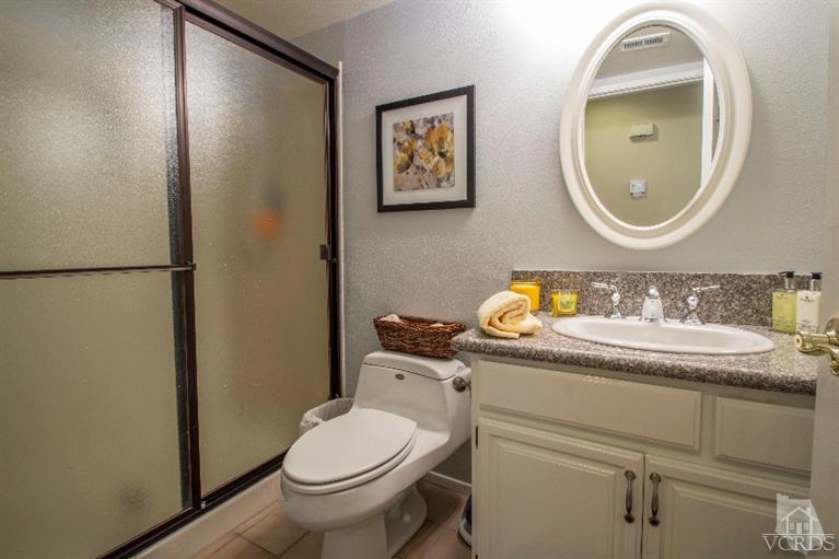 520 Fresh Meadows Road Simi Valley, CA 93065 - Photo 12 of 26 a bathroom with a granite countertop toilet sink and mirror