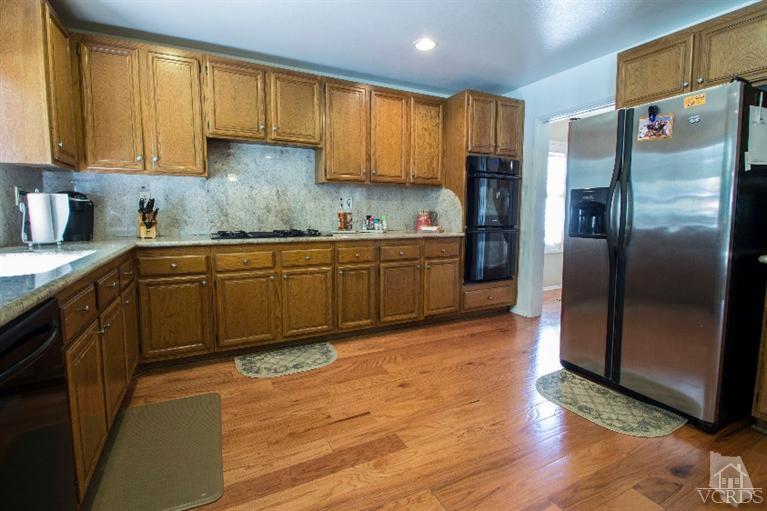520 Fresh Meadows Road Simi Valley, CA 93065 - Photo 14 of 26 a kitchen with stainless steel appliances granite countertop a refrigerator sink and cabinets