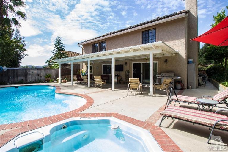 520 Fresh Meadows Road Simi Valley, CA 93065 - Photo 17 of 26 a view of a patio with table and chairs under an umbrella