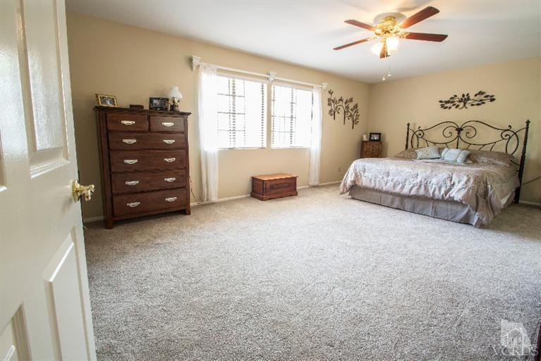 520 Fresh Meadows Road Simi Valley, CA 93065 - Photo 5 of 26 a bedroom with a bed and a chandelier