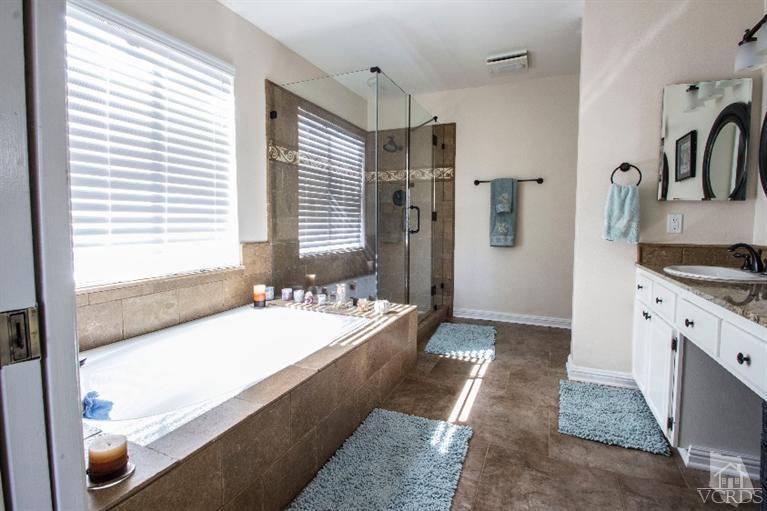 520 Fresh Meadows Road Simi Valley, CA 93065 - Photo 7 of 26 a spacious bathroom with a tub sink and mirror