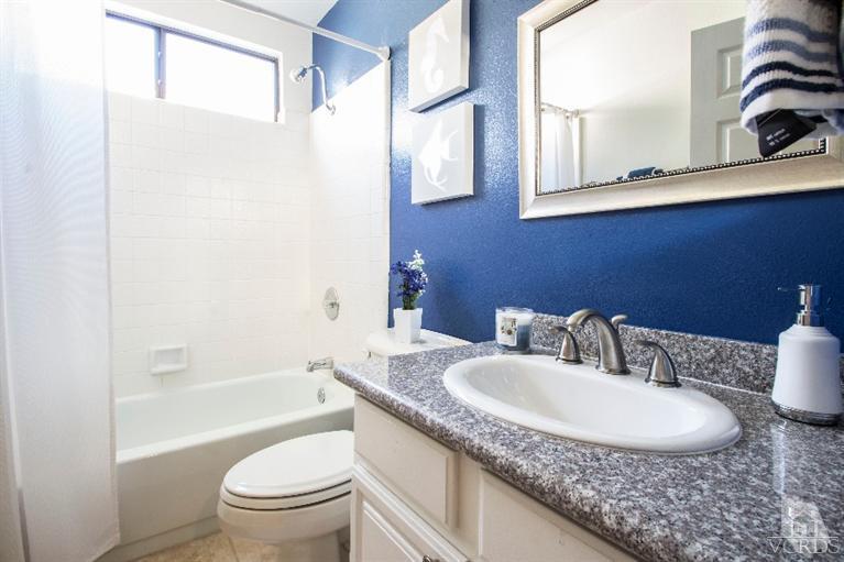 520 Fresh Meadows Road Simi Valley, CA 93065 - Photo 10 of 26 a bathroom with a granite countertop sink a toilet and bathtub