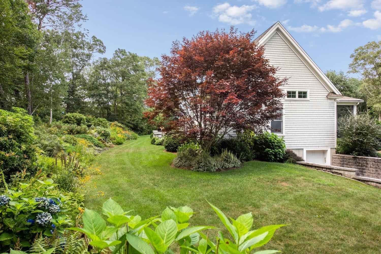 455 Turtleback Road Marstons Mills, MA 02648 - Photo 11 of 29 a view of a backyard with plants and large trees