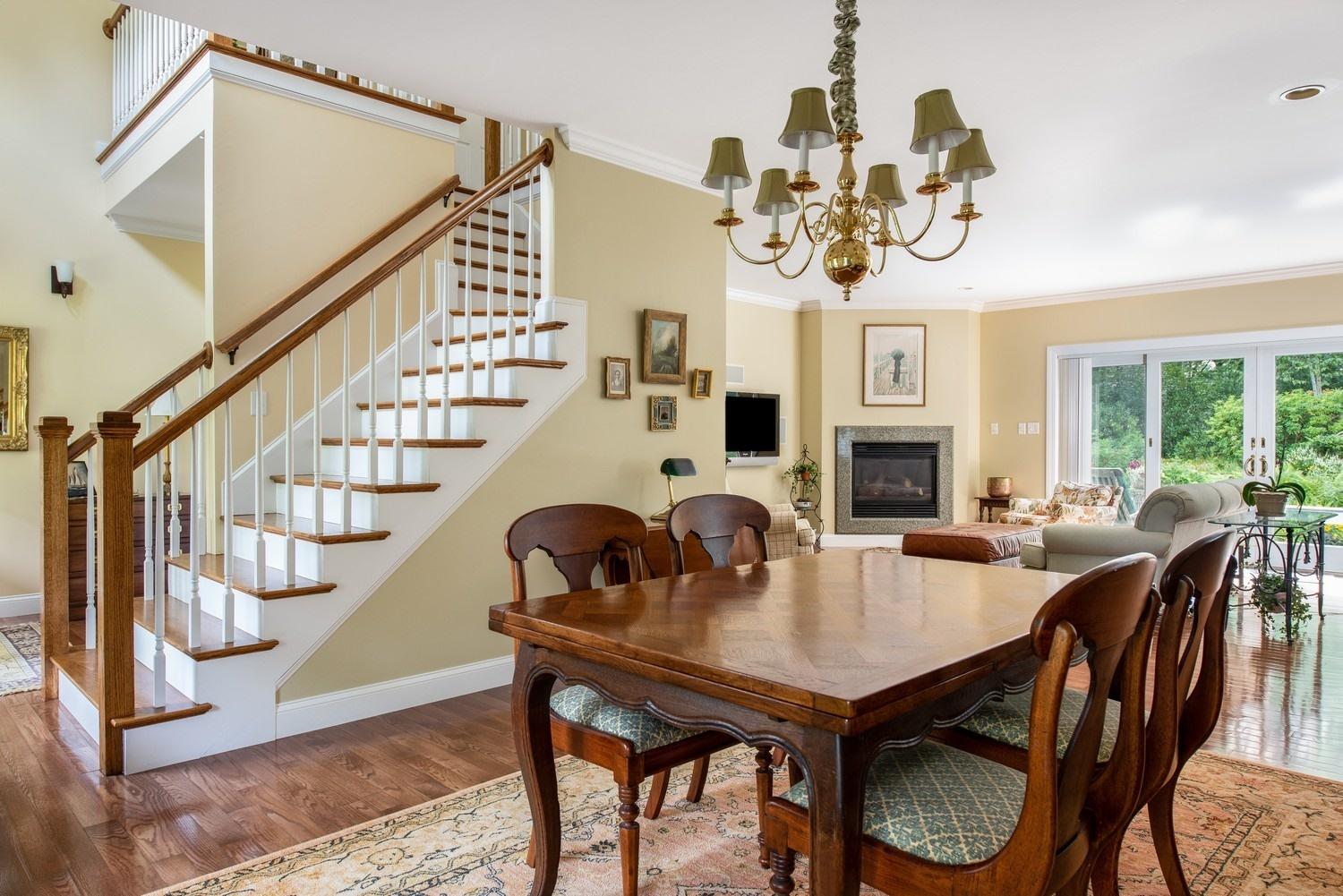 455 Turtleback Road Marstons Mills, MA 02648 - Photo 19 of 29 a view of a dining room with furniture a chandelier and wooden floor