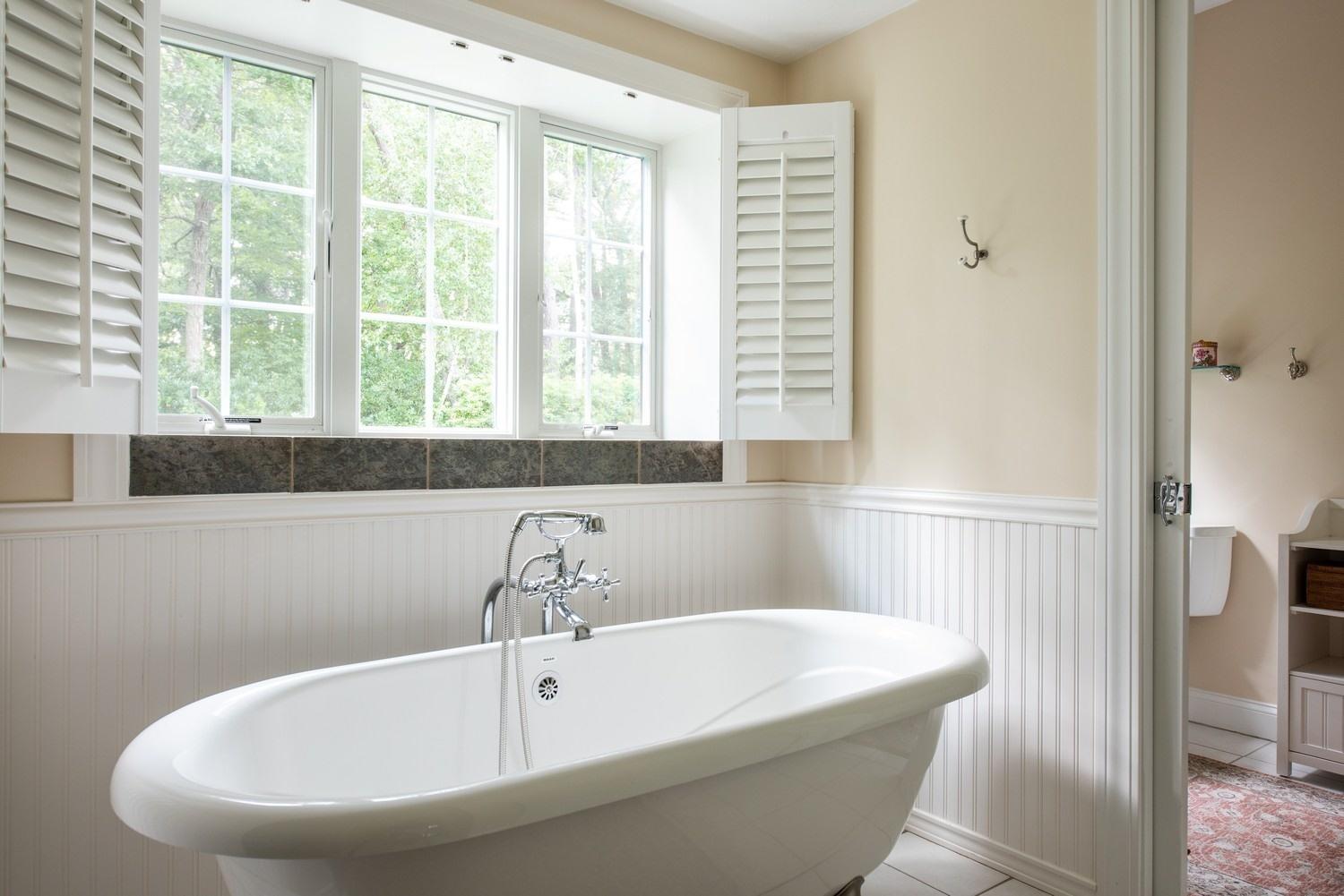 455 Turtleback Road Marstons Mills, MA 02648 - Photo 22 of 29 a white bath tub sitting in a bathroom next to a window