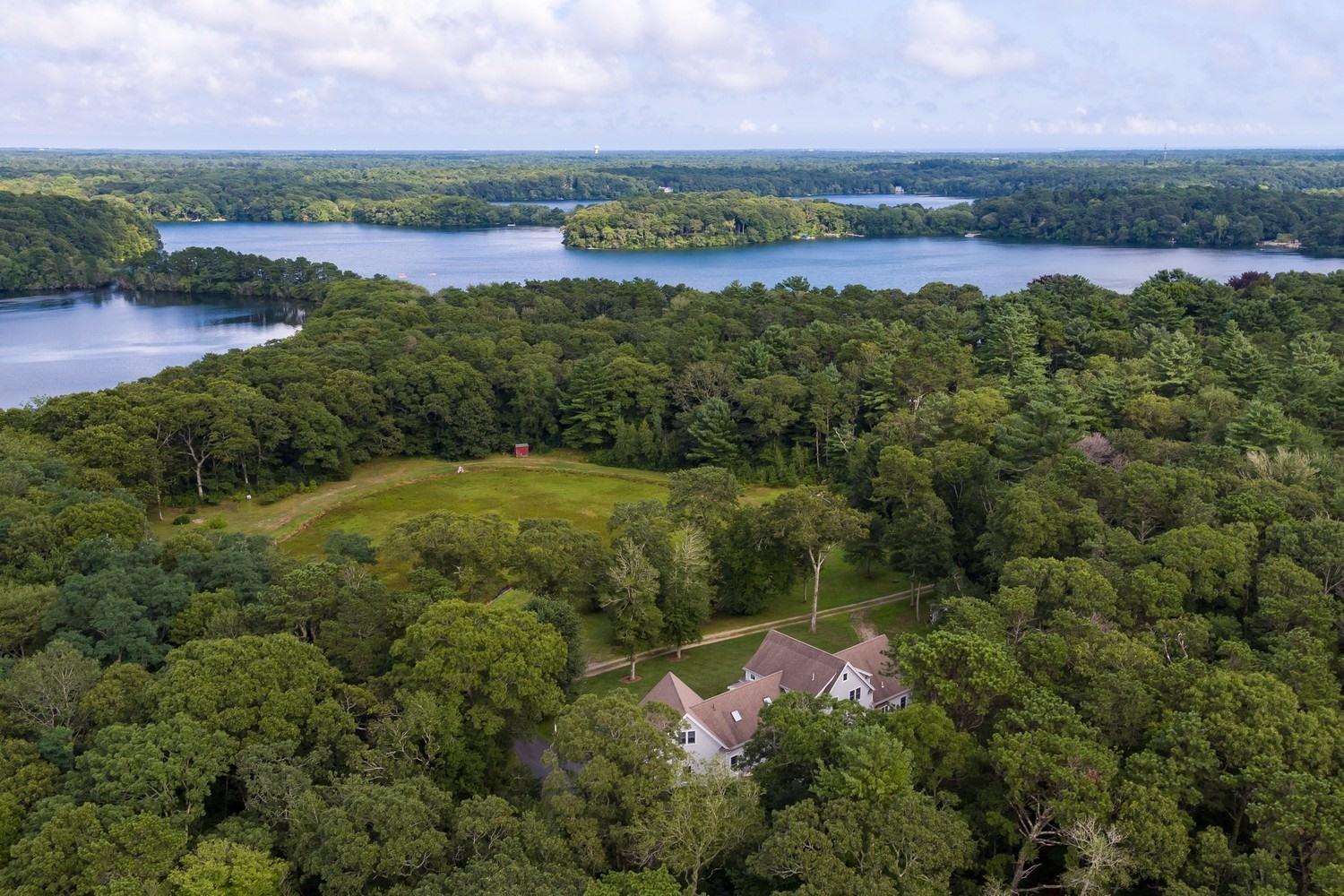 455 Turtleback Road Marstons Mills, MA 02648 - Photo 26 of 29 an aerial view of a city with lots of residential buildings and mountain view in back