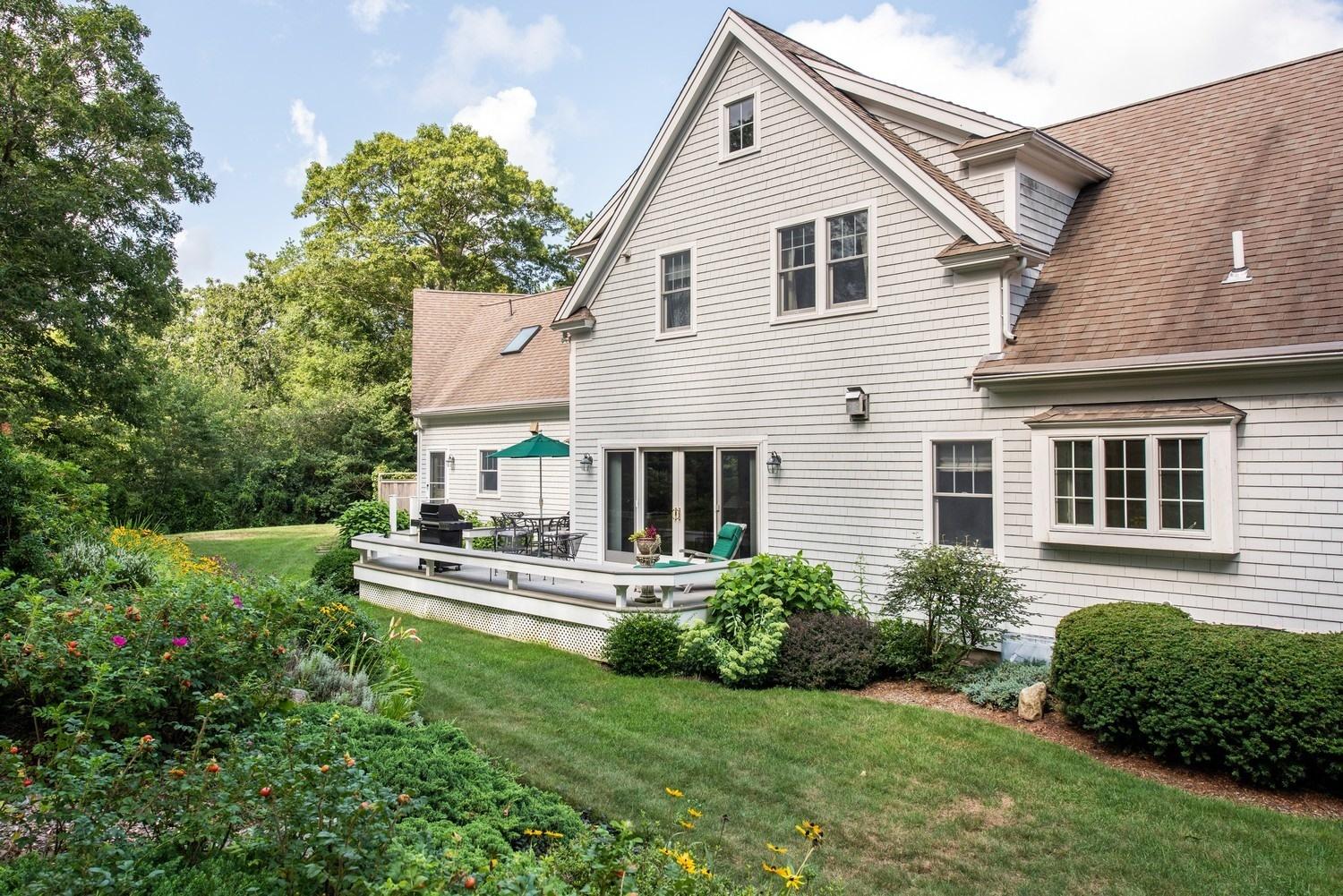 455 Turtleback Road Marstons Mills, MA 02648 - Photo 10 of 29 a front view of a house with a yard table and chairs