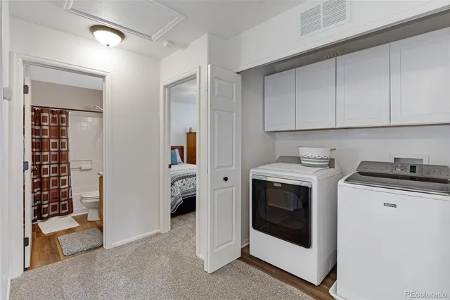 a utility room with sink dryer and washer