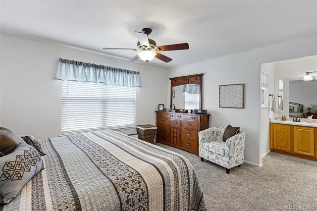 a bedroom with double bed and a chandelier