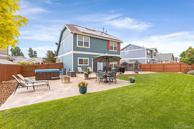 a view of a patio with chairs and plants
