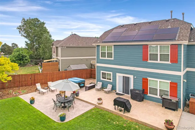 a view of a backyard with a patio and a fire pit