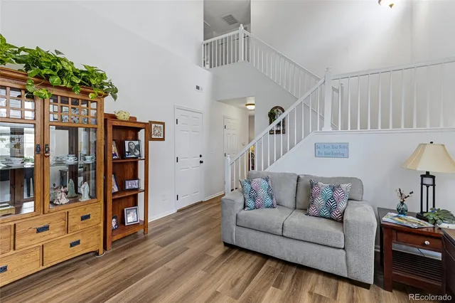 a living room with furniture and wooden floor