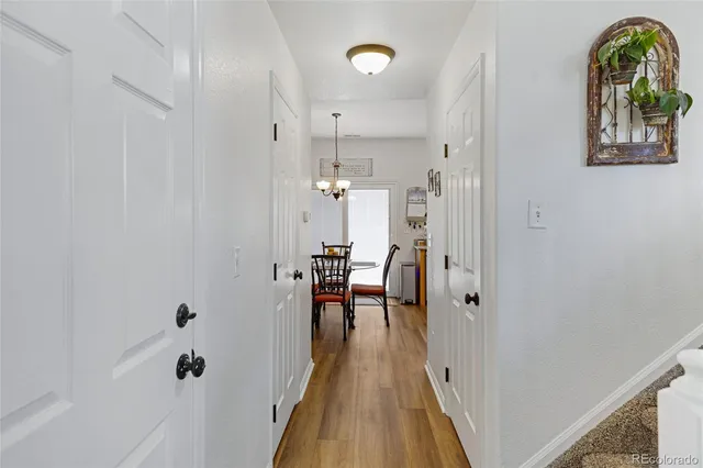 a view of a hallway view with wooden floor and staircase