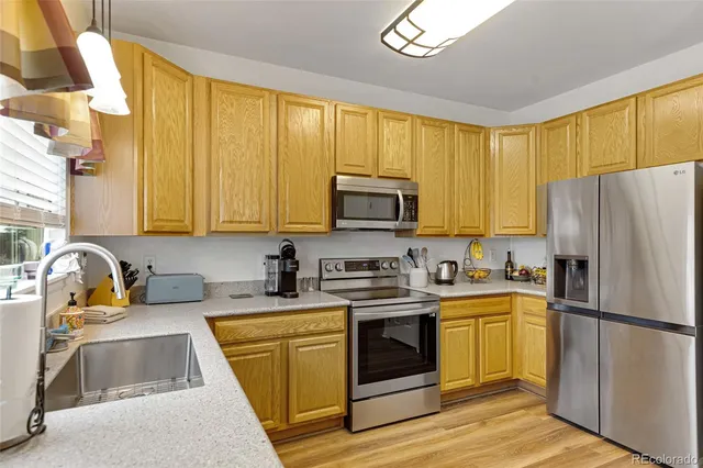 a kitchen with a sink stove and refrigerator