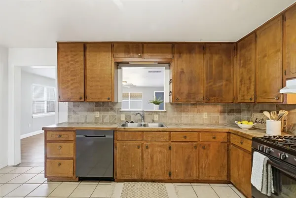 a kitchen with a sink window and cabinets