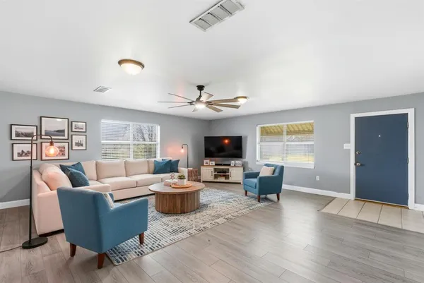 a living room with furniture and a flat screen tv