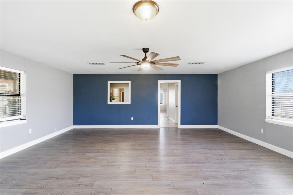504 North Hall Street Hamilton, TX 76531 - Photo 16 of 31 a view of an empty room with wooden floor and a window